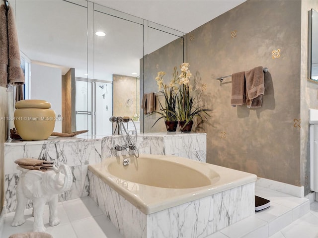 bathroom featuring a relaxing tiled bath and tile floors