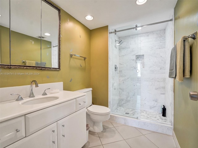 bathroom featuring walk in shower, tile flooring, large vanity, and toilet