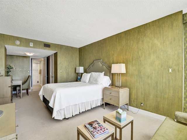 carpeted bedroom featuring a textured ceiling