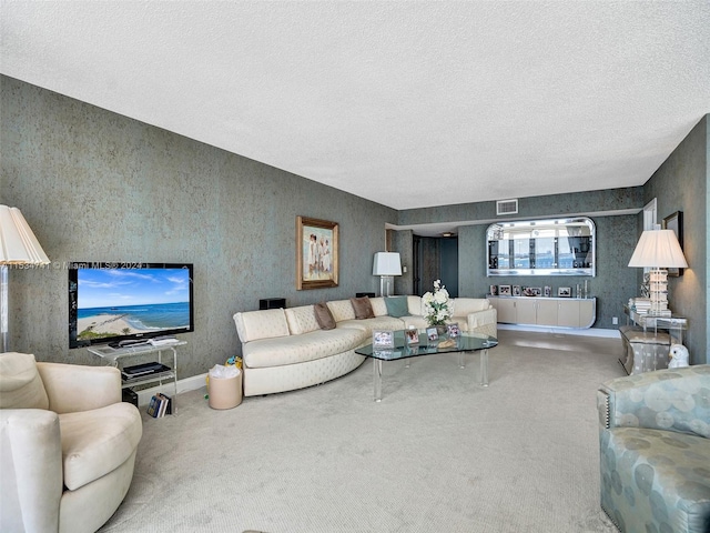 living room with a textured ceiling and carpet