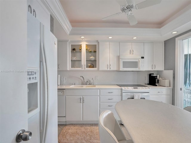 kitchen featuring white appliances, ceiling fan, light tile floors, sink, and white cabinets