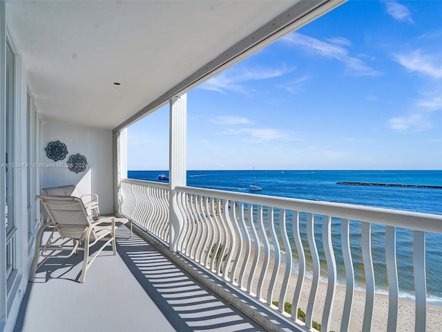 balcony with a beach view and a water view