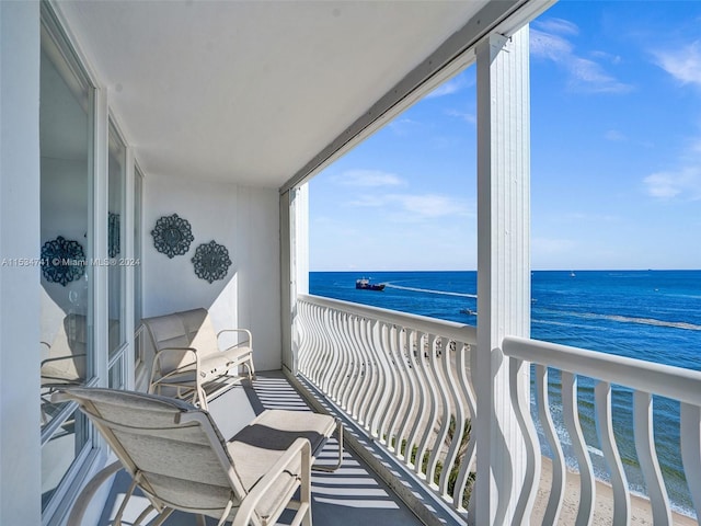 balcony featuring a water view