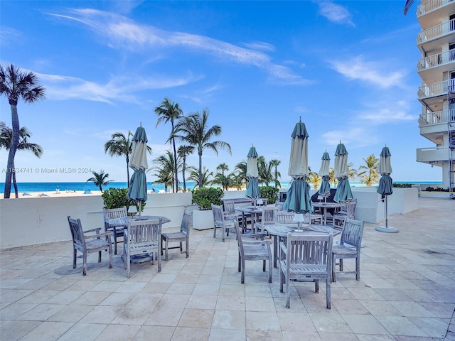 view of patio / terrace with a balcony and a water view