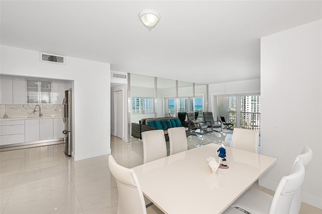 dining room with light tile floors and sink