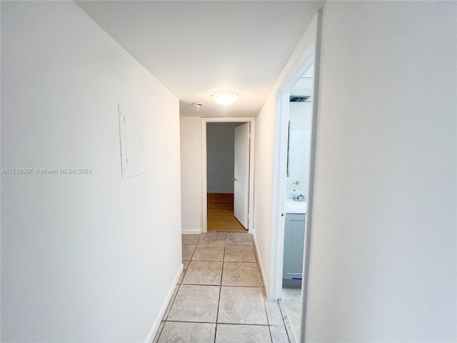 hall with light tile patterned floors