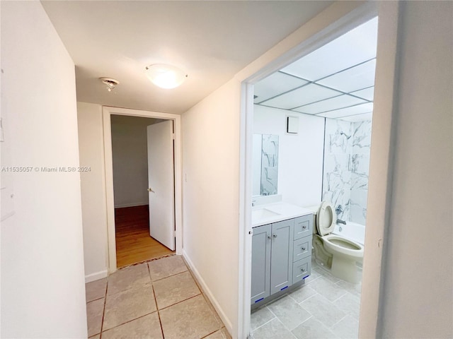 bathroom featuring toilet, vanity, and tile patterned flooring