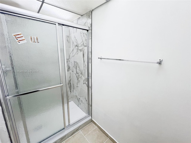 bathroom featuring walk in shower and tile patterned flooring