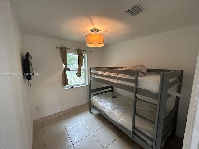 bedroom with light tile floors