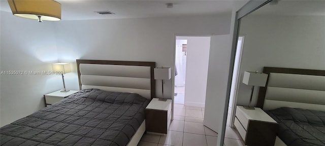 bedroom featuring light tile floors