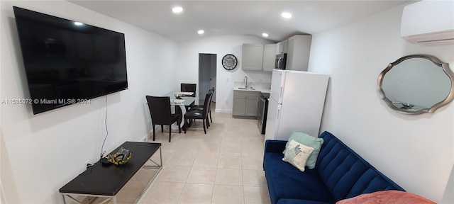 tiled living room with an AC wall unit, sink, and vaulted ceiling