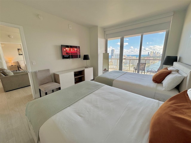 bedroom featuring access to outside and light hardwood / wood-style flooring