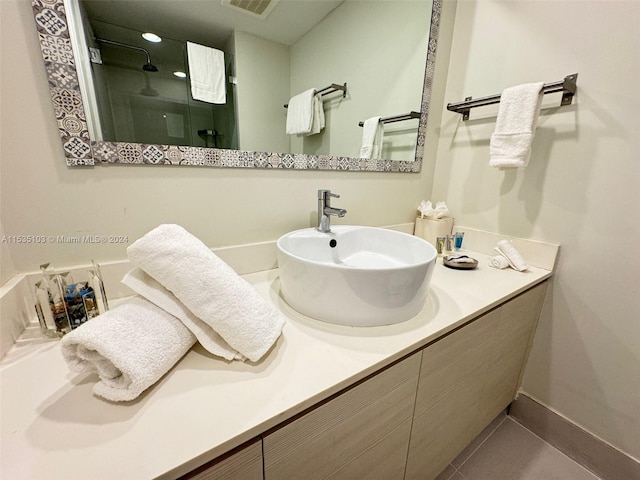 bathroom featuring large vanity and tile floors