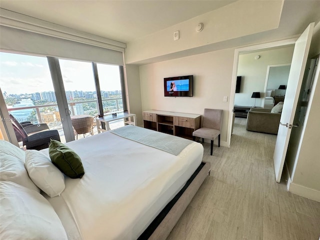 bedroom featuring french doors and light hardwood / wood-style flooring