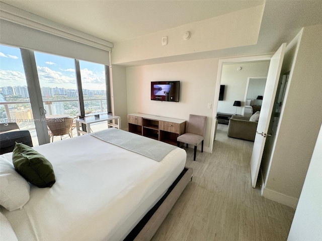 bedroom featuring french doors and light hardwood / wood-style floors