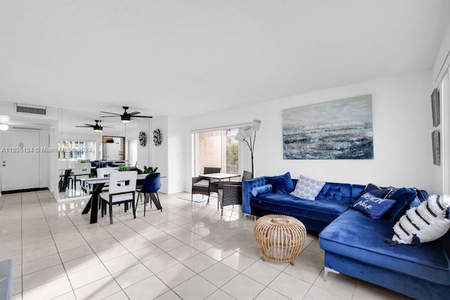 living room featuring ceiling fan and light tile patterned floors