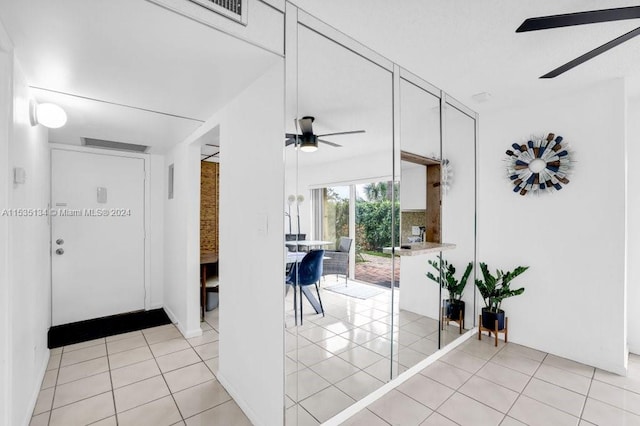 hall with light tile patterned flooring