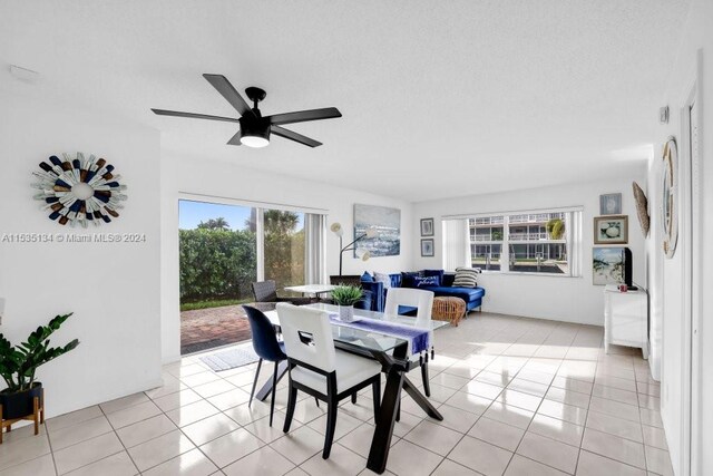 dining area featuring light tile patterned floors, a wealth of natural light, and ceiling fan