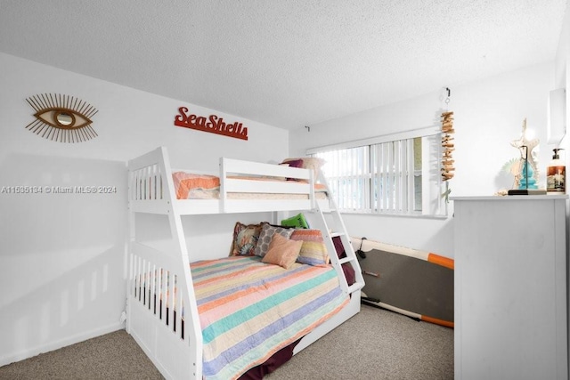 bedroom featuring carpet flooring and a textured ceiling