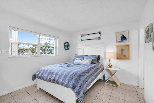 bedroom with light tile patterned floors