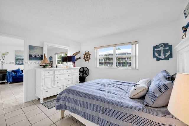 tiled bedroom with a textured ceiling