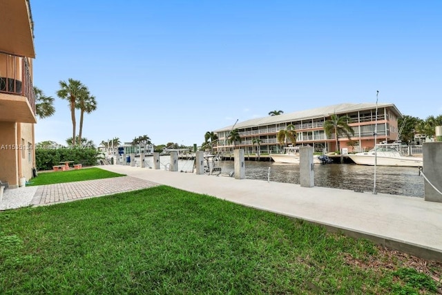 dock area with a yard and a water view