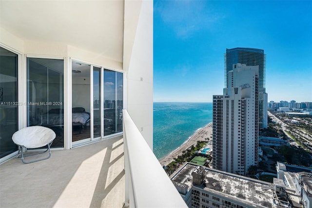 balcony with a view of the beach and a water view