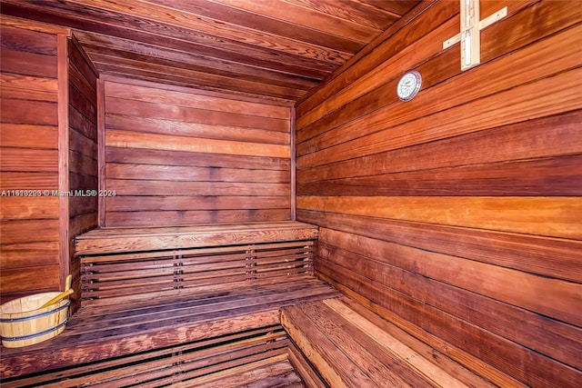 view of sauna / steam room with wood ceiling and wooden walls