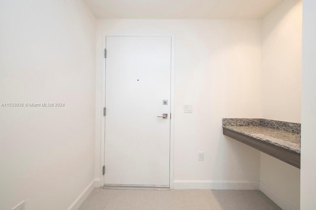 doorway to outside featuring light tile flooring