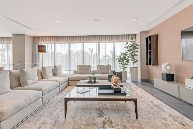 living room with plenty of natural light and tile floors