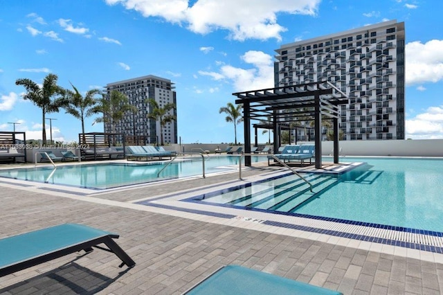 view of swimming pool with a patio and a pergola