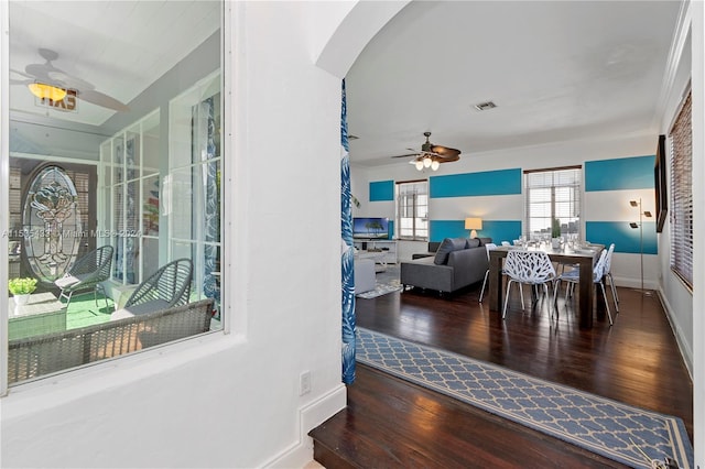 interior space with ceiling fan and dark wood-type flooring