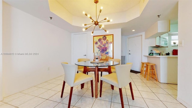 dining space featuring a raised ceiling, light tile flooring, and a chandelier