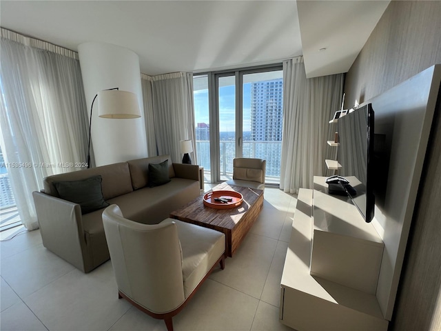 tiled living room featuring a water view and a wall of windows