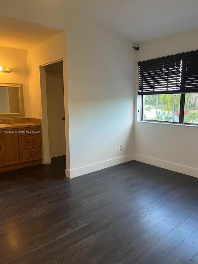 spare room featuring dark wood-type flooring