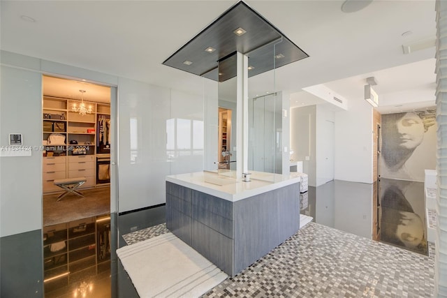 bathroom featuring walk in shower, tile flooring, and a chandelier