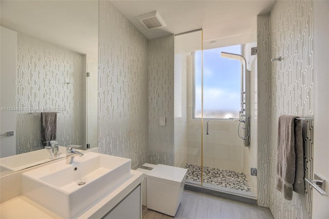 bathroom featuring tile floors, an enclosed shower, toilet, and vanity