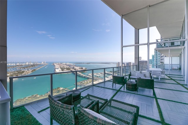 balcony featuring a water view and an outdoor hangout area