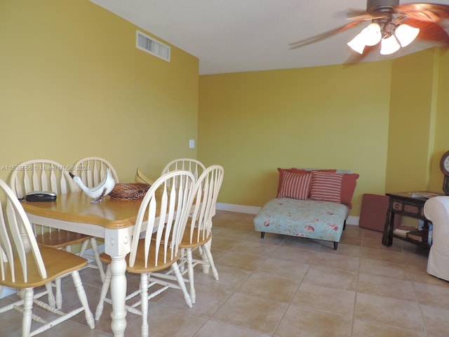 dining space featuring light tile floors and ceiling fan