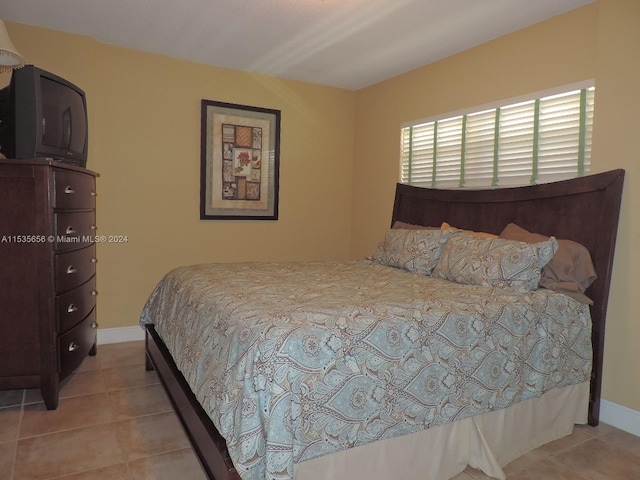 bedroom featuring light tile floors