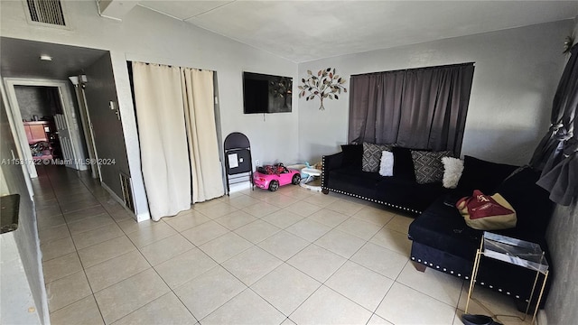 living room with light tile flooring and vaulted ceiling