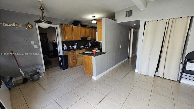 kitchen featuring backsplash, pendant lighting, and light tile floors