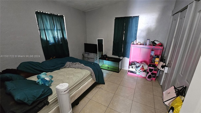 bedroom with light tile floors