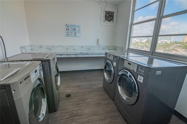 laundry room with dark hardwood / wood-style floors and independent washer and dryer