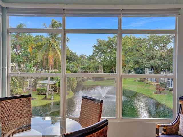 sunroom with a water view and plenty of natural light