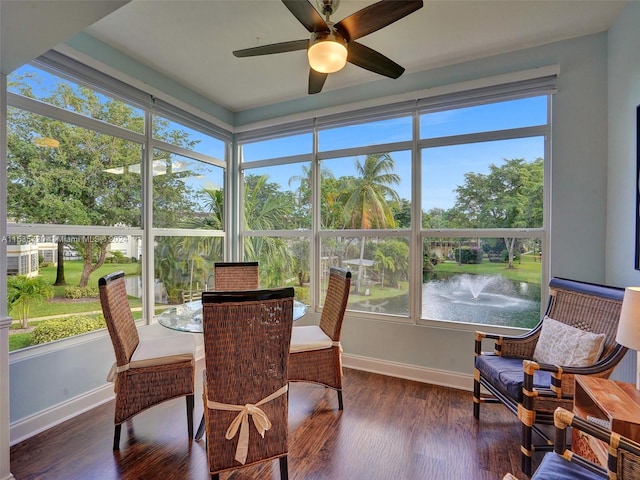 sunroom / solarium with ceiling fan, a healthy amount of sunlight, and a water view