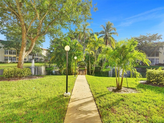 surrounding community featuring a water view and a yard