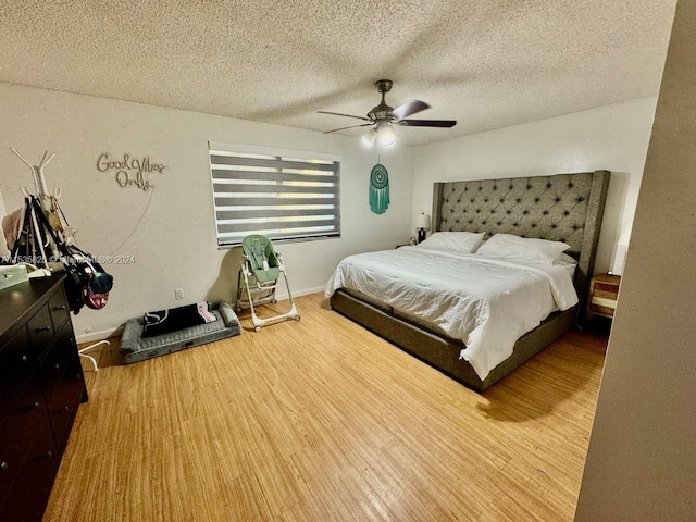 bedroom featuring ceiling fan, a textured ceiling, and wood-type flooring