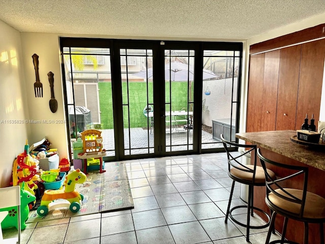 entryway featuring a textured ceiling and light tile floors