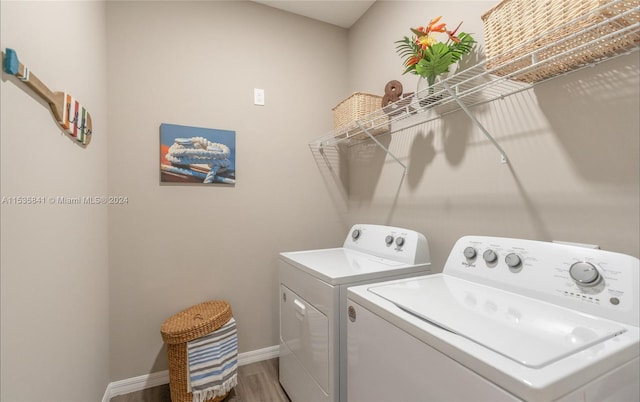 laundry room with separate washer and dryer and wood-type flooring